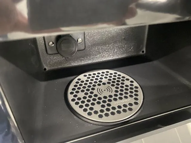 Slide: The Image of 2024 Regal LS6 boat interior with white leather seating and cup holders. - 26