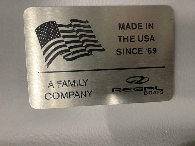 Slide: The Image of 2024 Regal LS6 boat interior with white leather seating and cup holders. - 27