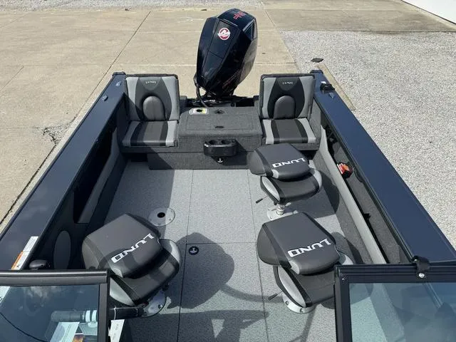 Slide: The Image of 2024 Lund 1875 Crossover XS Sport boat interior with seating and outboard motor. - 12