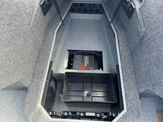 Slide: The Image of 2024 Lund 1875 Crossover XS Sport boat storage compartment with battery and tray. - 14