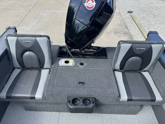 Slide: The Image of 2024 Lund 1875 Crossover XS Sport boat interior with dual seats and Mercury outboard motor. - 15