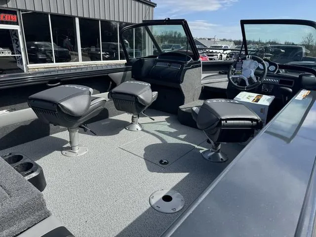 Slide: The Image of 2024 Lund 1875 Crossover XS Sport boat interior with seating and steering console. - 3