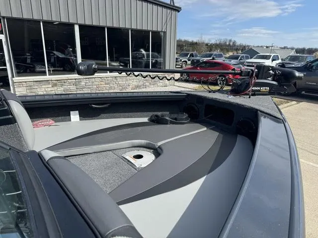 Slide: The Image of 2024 Lund 1875 Crossover XS Sport boat deck with trolling motor in dealership lot. - 4