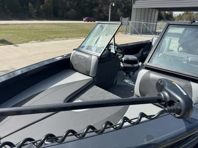 Slide: The Image of 2024 Lund 1875 Crossover XS Sport boat interior with windshield and seating. - 6