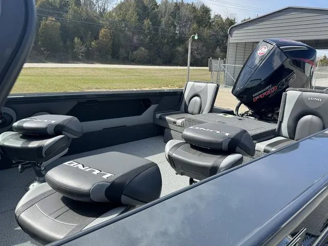 Slide: The Image of 2024 Lund 1875 Crossover XS Sport boat interior with seating and outboard motor. - 7