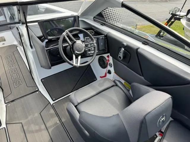Slide: The Image of 2025 Scarab 235 Wake boat interior with modern dashboard and steering wheel. - 10