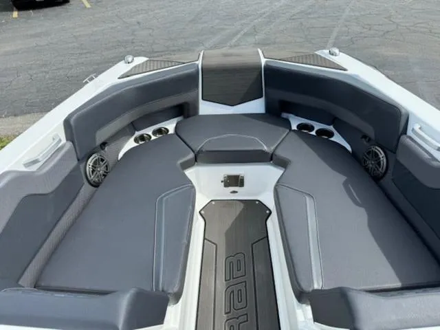 Slide: The Image of 2025 Scarab 235 Wake boat interior with gray seating and built-in speakers. - 15