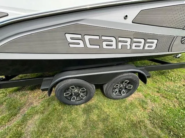 Slide: The Image of 2025 Scarab 235 Wake boat on trailer, side view. - 5