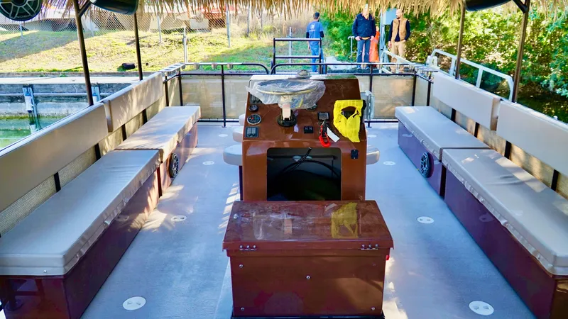 Slide: The Image of 2024 A&M Manufacturing BullDog 30 pontoon boat interior with seating and control console. - 1