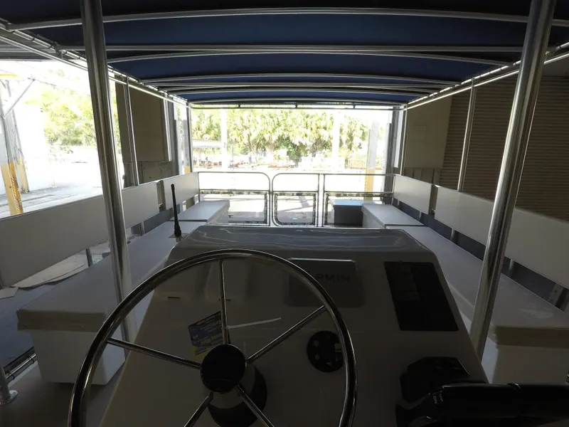 Slide: The Image of 2024 A&M Manufacturing BullDog 30 boat interior with steering wheel and seating. - 10