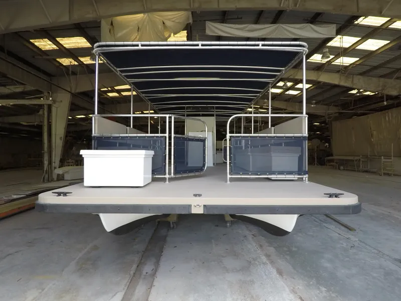 Slide: The Image of 2024 A&M Manufacturing BullDog 30 pontoon boat in a warehouse. - 9