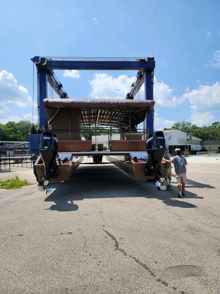 Slide: The Image of 2024 A&M Manufacturing BullDog 50 boat being transported by a large crane. - 12