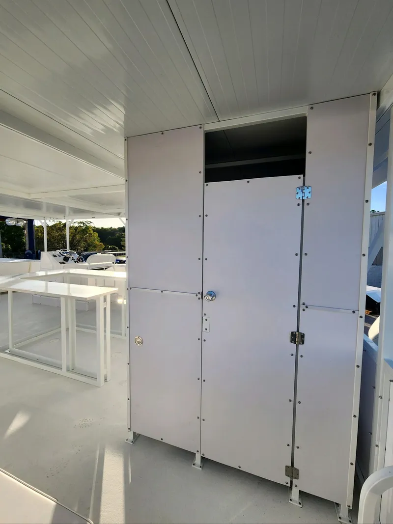 Slide: The Image of 2024 A&M Manufacturing BullDog 50 interior with white panels and storage compartments. - 20