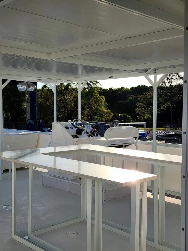 Slide: The Image of 2024 A&M Manufacturing BullDog 50 boat interior with white seating and tables. - 21