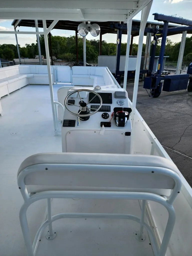 Slide: The Image of 2024 A&M Manufacturing BullDog 50 boat interior with steering console and seating. - 27