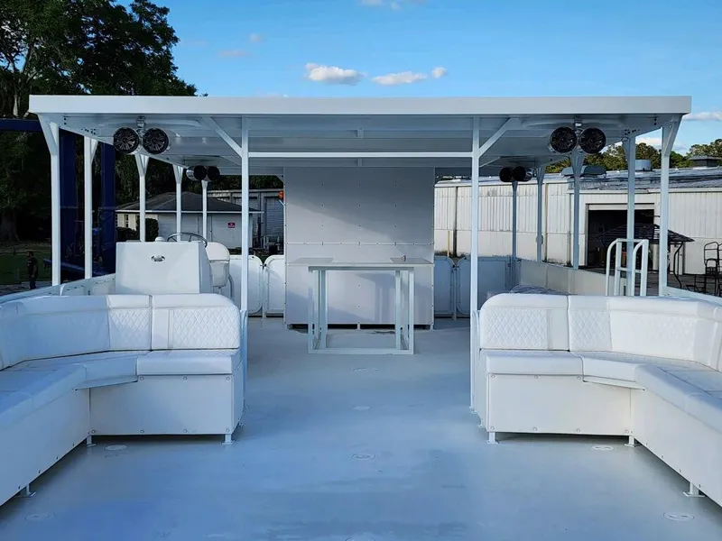 Slide: The Image of 2024 A&M Manufacturing BullDog 50 boat with spacious seating and covered deck. - 29