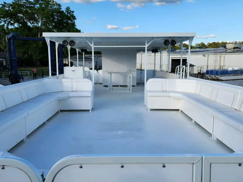 Slide: The Image of 2024 A&M Manufacturing BullDog 50 pontoon boat with spacious seating and canopy. - 31
