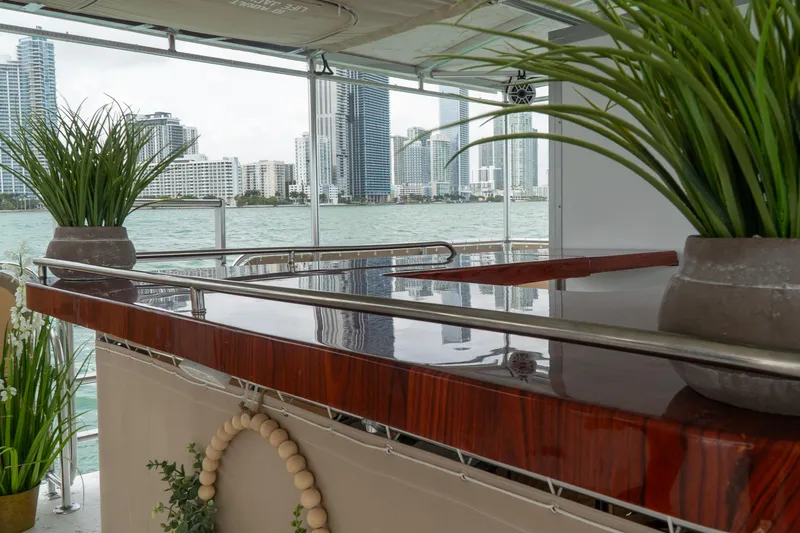 Slide: The Image of Luxurious bar area on the 2024 A&M Manufacturing BullDog 50 yacht with city skyline view. - 7