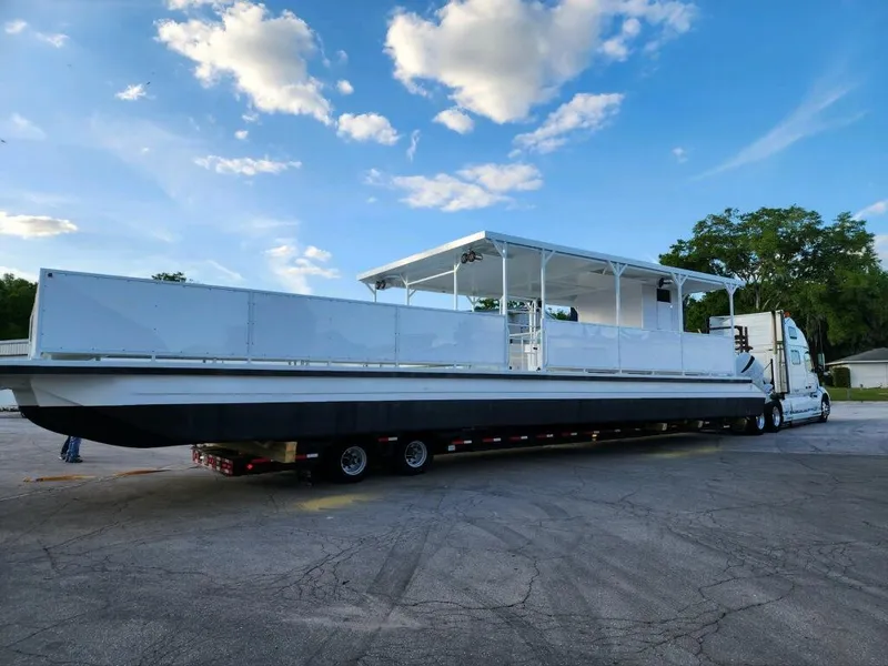 Slide: The Image of 2024 A&M Manufacturing BullDog 50 boat on a trailer under a blue sky. - 8
