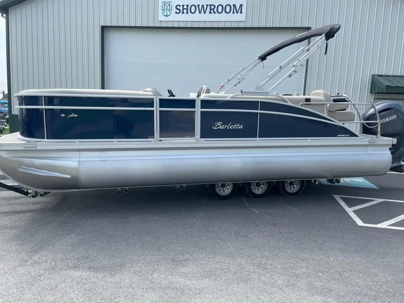 Slide: The Image of 2024 Barletta Aria 22CC pontoon boat outside showroom. - 1