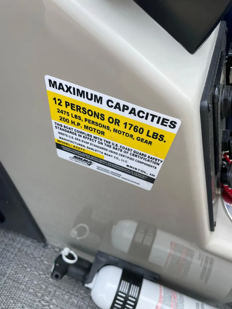 Slide: The Image of 2024 Barletta Aria 22CC maximum capacities label, 12 persons or 1760 lbs, 200 HP motor. - 10