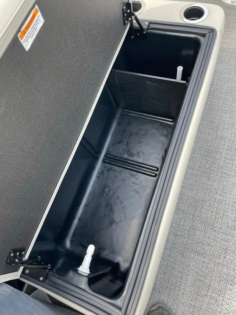 Slide: The Image of 2024 Barletta Aria 22CC storage compartment with cup holders. - 11