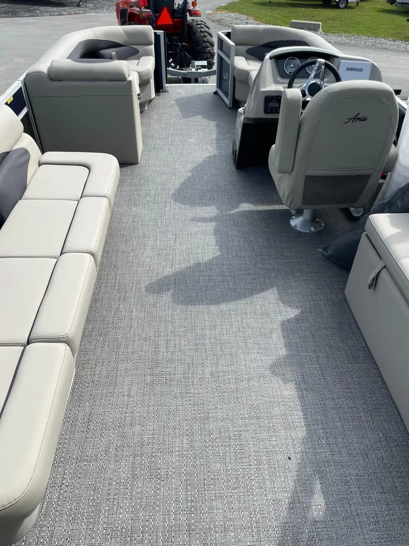 Slide: The Image of 2024 Barletta Aria 22CC pontoon boat interior with beige seating and modern helm. - 16