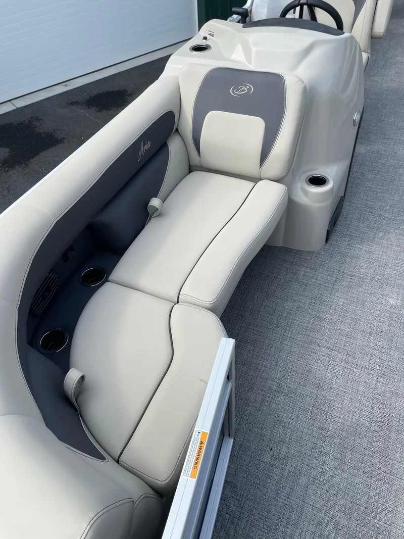 Slide: The Image of 2024 Barletta Aria 22CC boat interior with beige seating and cup holders. - 7