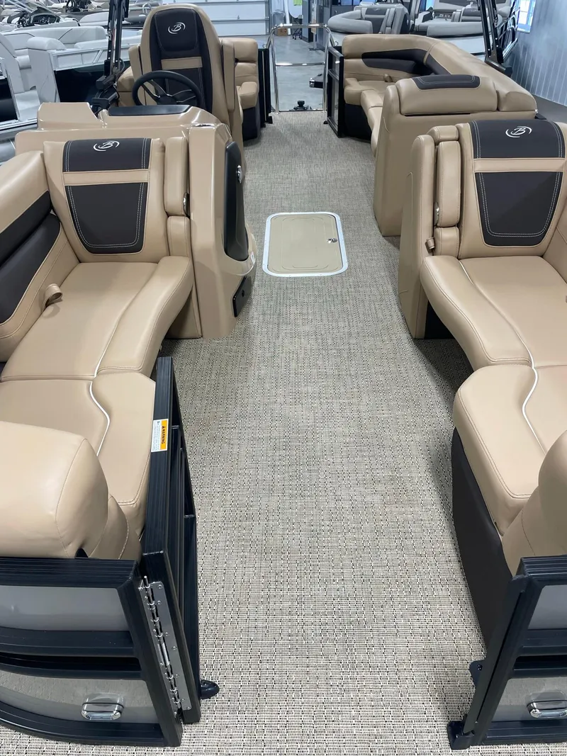 Slide: The Image of 2024 Barletta Cabrio 22Q pontoon boat interior with beige seating and carpet. - 10