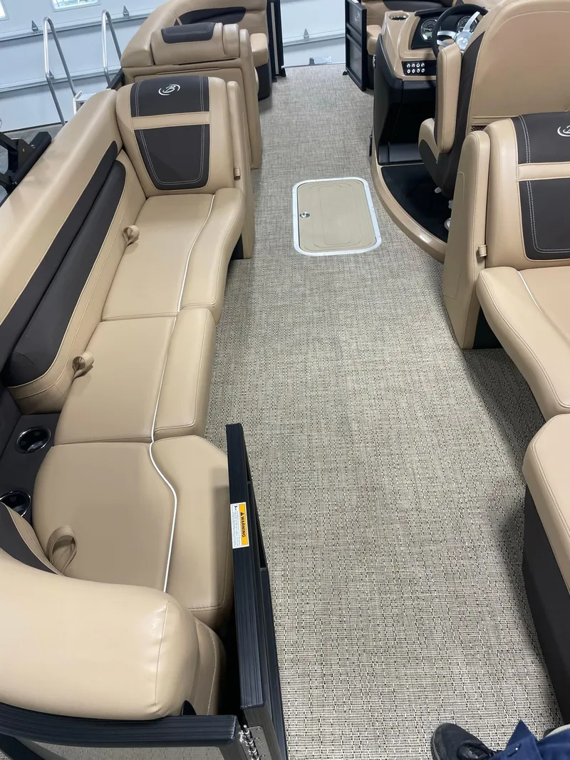 Slide: The Image of 2024 Barletta Cabrio 22Q interior with beige and brown seating, spacious layout. - 16