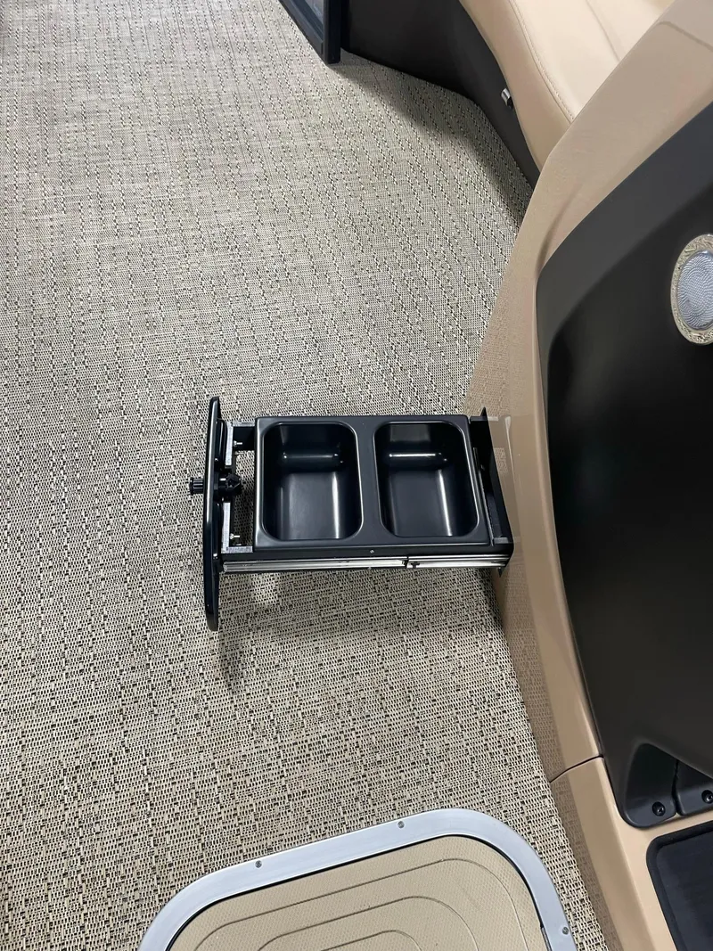 Slide: The Image of 2024 Barletta Cabrio 22Q boat interior with retractable cup holders. - 18