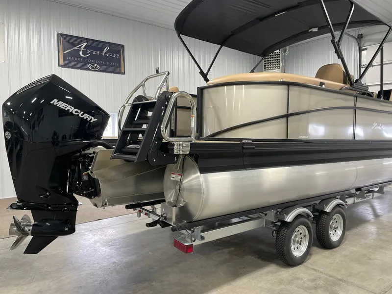 Slide: The Image of 2024 Barletta Cabrio 22Q pontoon boat on trailer with Mercury outboard motor. - 2