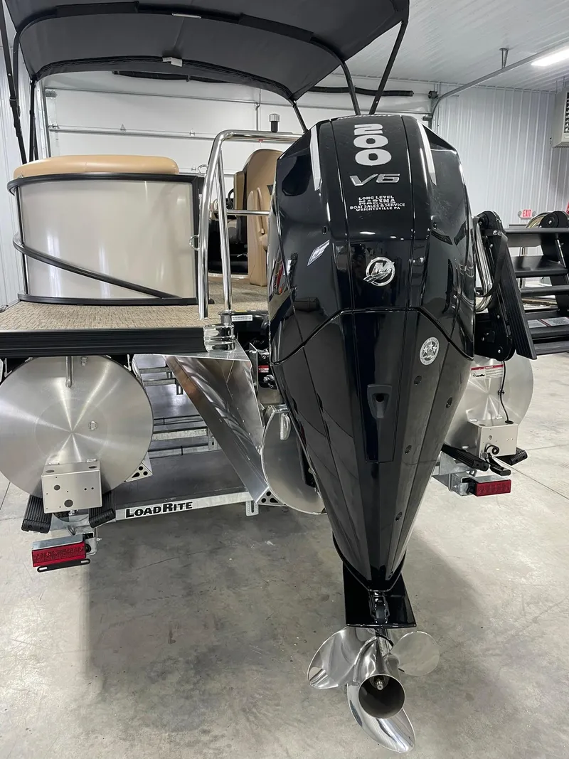 Slide: The Image of 2024 Barletta Cabrio 22Q pontoon boat with powerful 200 V6 engine in a showroom. - 3