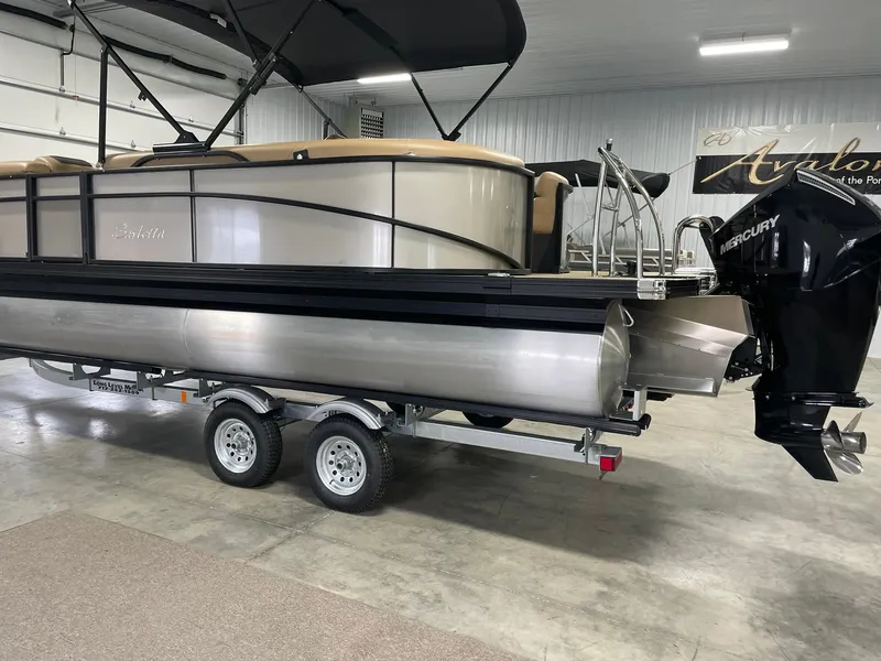 Slide: The Image of 2024 Barletta Cabrio 22Q pontoon boat on trailer in indoor showroom. - 4