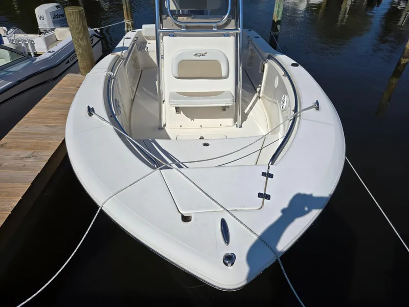 Slide: The Image of 2021 Bulls Bay 200 CC boat docked, showcasing bow and seating area. - 2