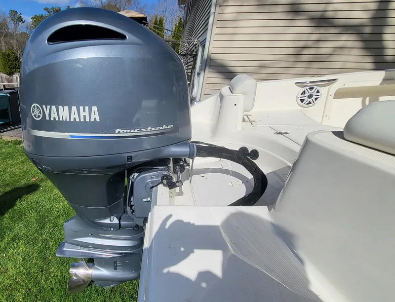 Slide: The Image of 2021 Bulls Bay 200 CC boat with Yamaha outboard motor, parked on grass. - 20