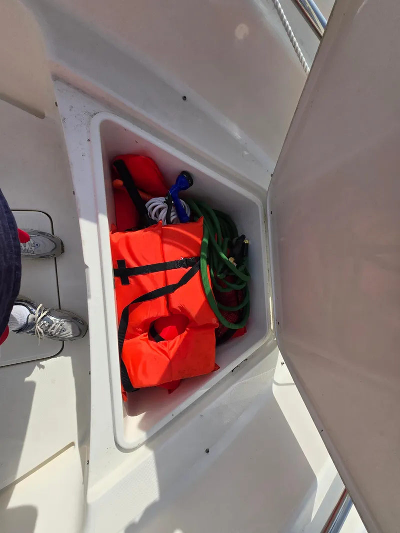 Slide: The Image of Storage compartment on a 2021 Bulls Bay 200 CC boat with life jackets and ropes. - 25