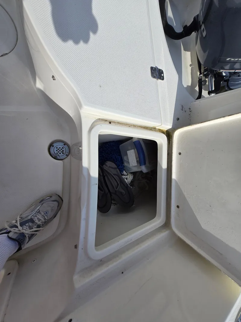 Slide: The Image of 2021 Bulls Bay 200 CC boat storage compartment with gear and accessories visible. - 29