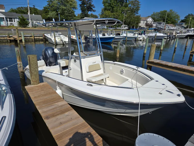 Slide: The Image of 2021 Bulls Bay 200 CC boat docked at a marina, featuring a center console design. - 3