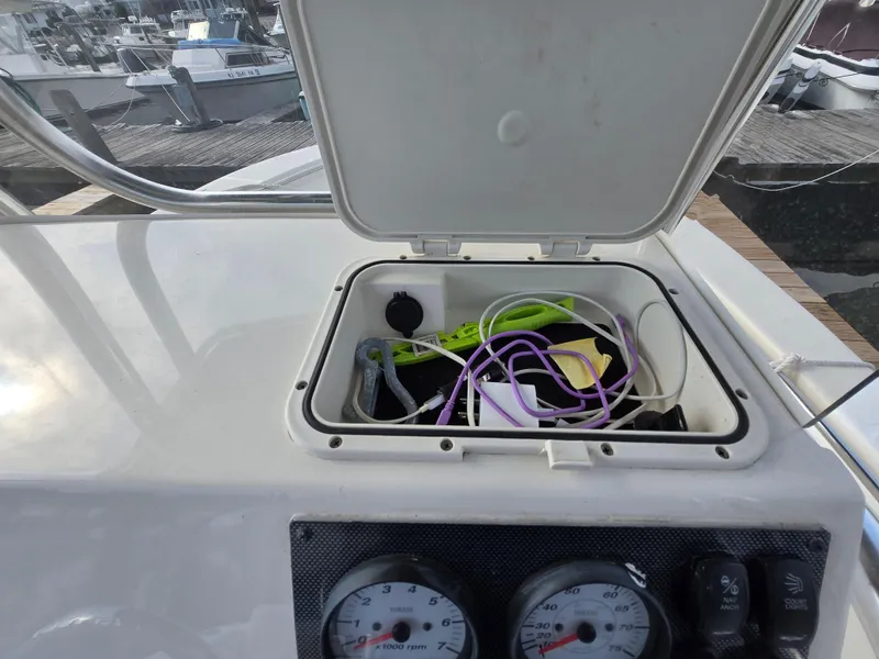 Slide: The Image of 2021 Bulls Bay 200 CC boat console with open storage compartment and gauges. - 34