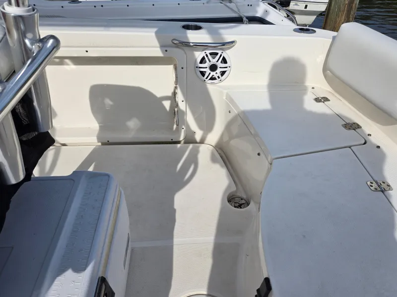 Slide: The Image of 2021 Bulls Bay 200 CC boat interior with seating and speaker, docked. - 37