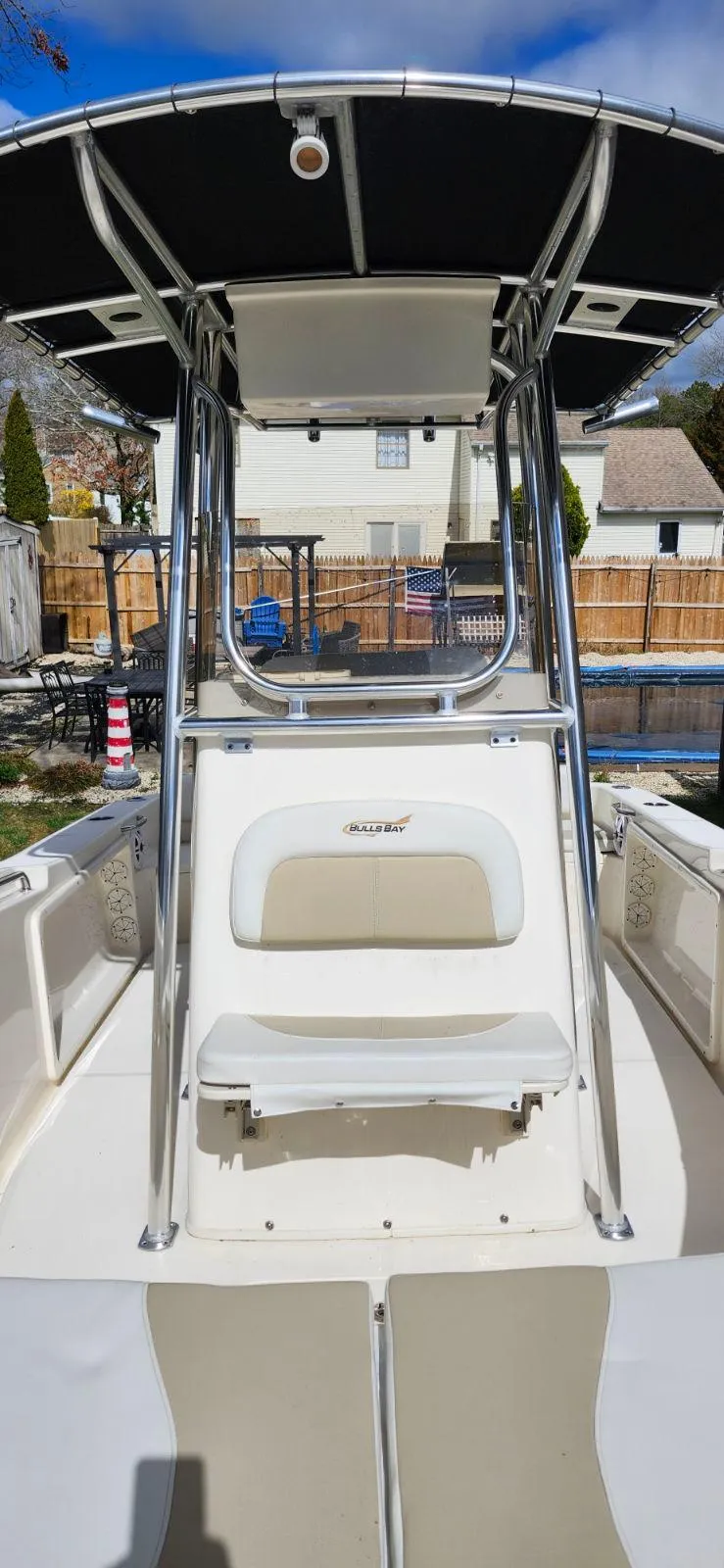 Slide: The Image of 2021 Bulls Bay 200 CC boat with T-top and seating, parked outdoors. - 8