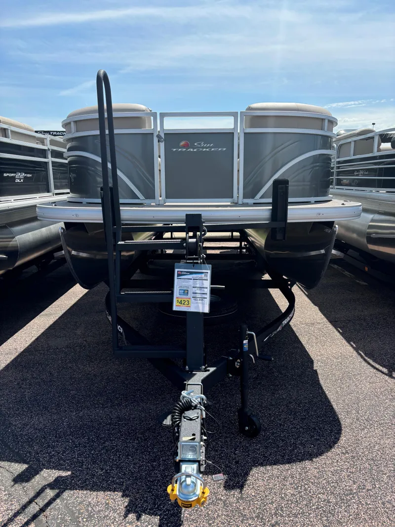 Slide: The Image of 2024 Sun Tracker Party Barge 24 DLX pontoon boat on trailer, front view. - 2