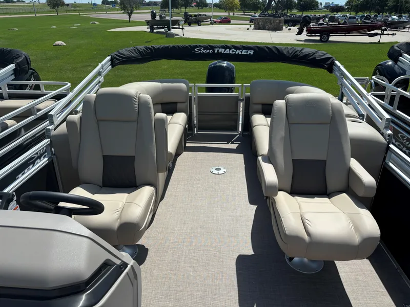 Slide: The Image of 2024 Sun Tracker Party Barge 24 DLX interior with plush seating and spacious layout. - 8