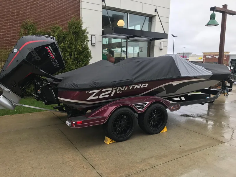Slide: The Image of 2024 Nitro Z21 XL Pro boat with cover on trailer. - 0