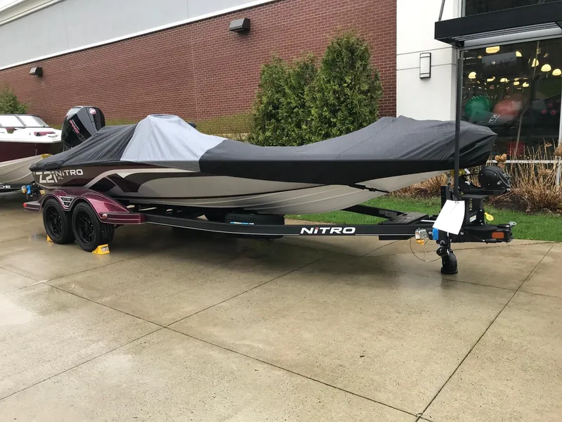 Slide: The Image of 2024 Nitro Z21 XL Pro boat with cover on trailer, parked outside. - 1