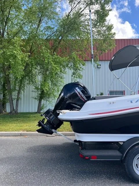 Slide: The Image of 2024 Tahoe 185 S boat with Mercury outboard motor on trailer. - 2