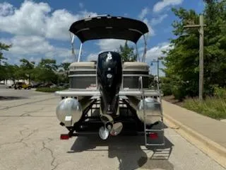 Slide: The Image of 2024 Sun Tracker Party Barge 24 DLX pontoon boat, rear view with outboard motor. - 3
