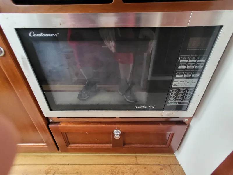 Slide: The Image of Built-in microwave oven in a 2012 Crusader Boats outboard cruiser kitchen. - 15
