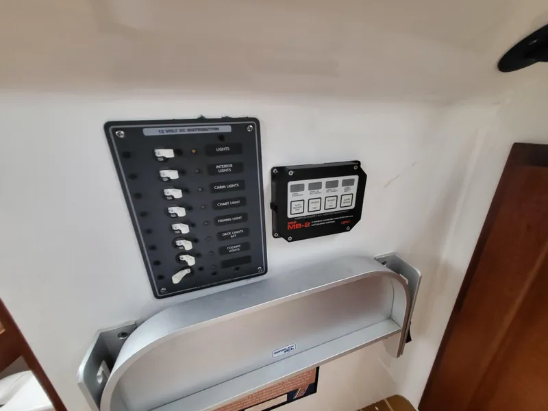 Slide: The Image of Control panel inside 2012 Crusader Boats outboard cruiser, featuring switches and digital display. - 19